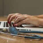 AI in healthcare technology - doctor using laptop with stethoscope