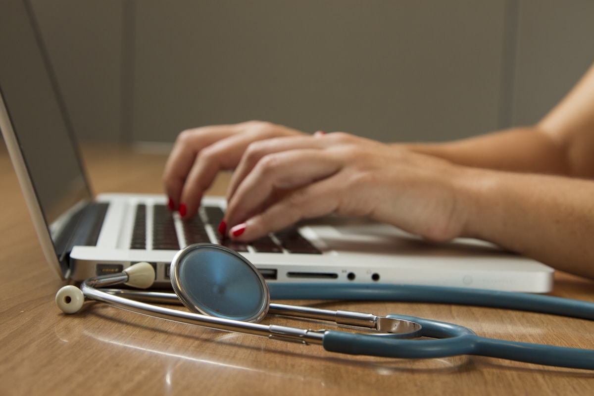 AI in healthcare technology - doctor using laptop with stethoscope
